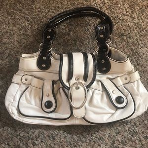 White purse with black trim
